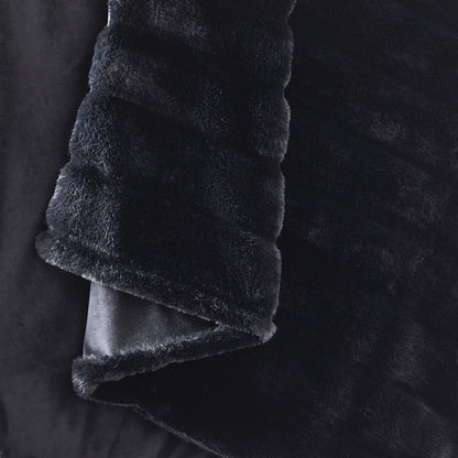 CozyBliss black faux fur throw blanket on a woman relaxing. Ultra-soft, warm, and stylish cozy bedding. #color_Black