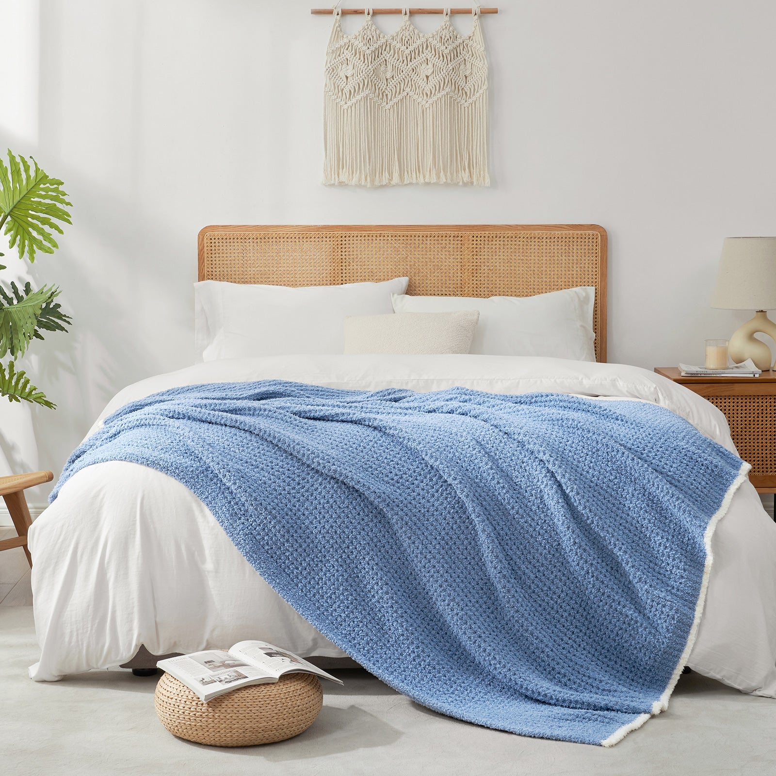 Soft Waffle Feather Yarn Throw Blanket in Denim Blue styled on a bed, adding a modern and cozy layered look. #color_Denim Blue