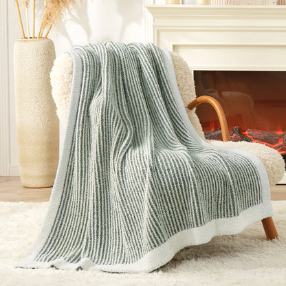 Soft Ribbed Feather Yarn Throw Blanket in Sage Green & White draped over an armchair, showcasing ribbed texture and soft feather yarn design. #color_Sage Green & White