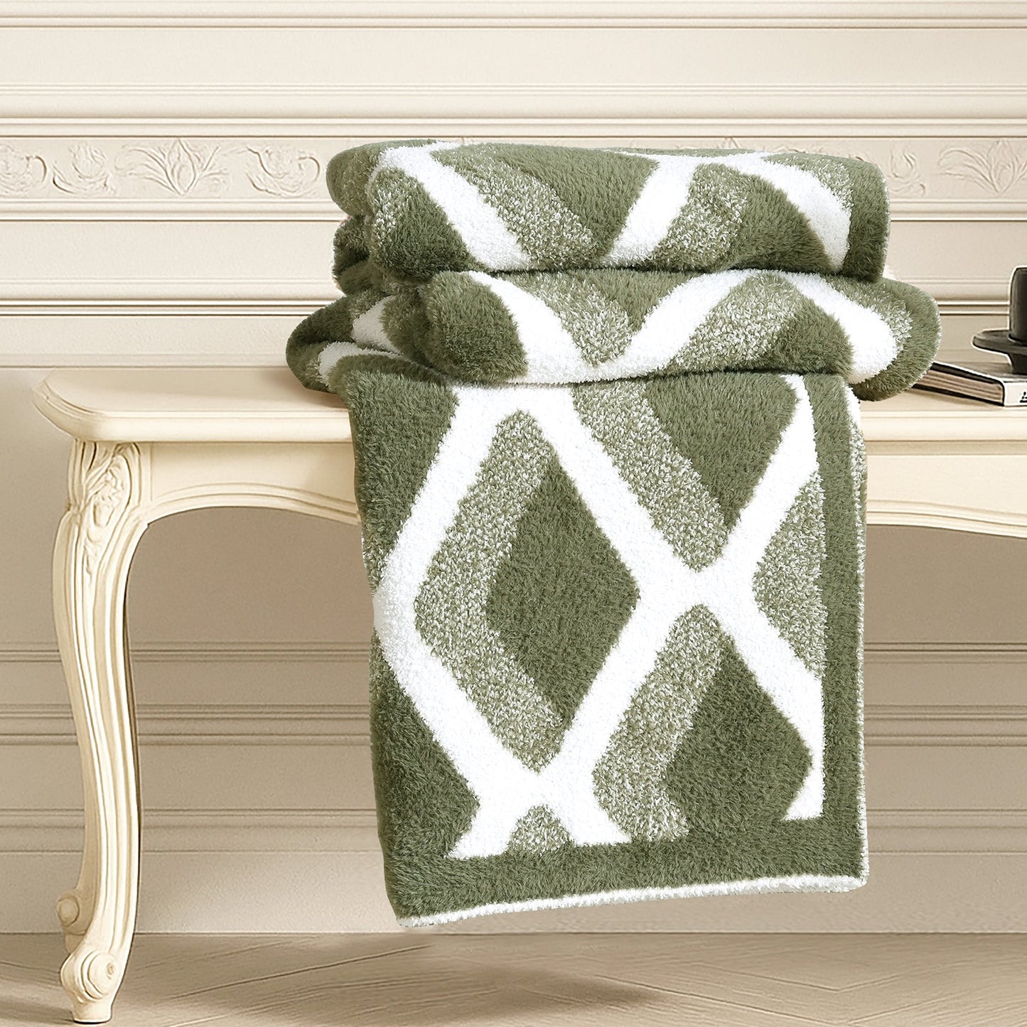 Diamond Feather Yarn Throw Blanket in Green neatly folded on a table, showcasing plush texture and detailed diamond knit design. #color_Green