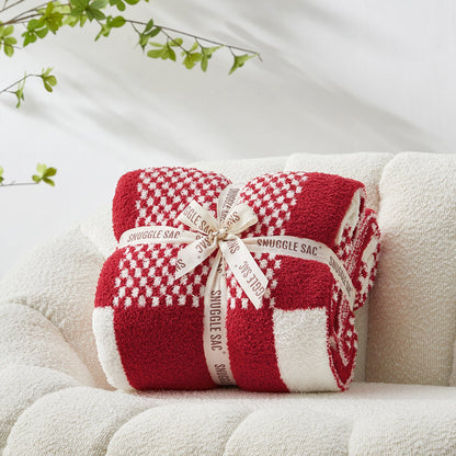 Checkered Feather Yarn Throw Blanket in Red & Cream front view neatly folded on a sofa, showcasing soft texture and checkered pattern design. #color_Red & Cream
