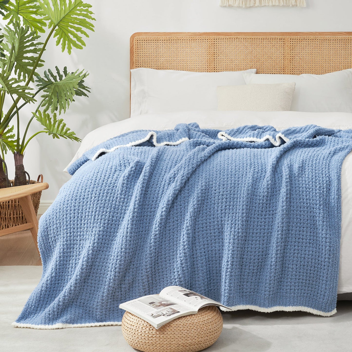 Soft Waffle Feather Yarn Throw Blanket in Denim Blue styled on a bed, adding a modern and cozy layered look. #color_Denim Blue