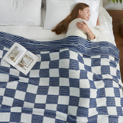 Woman sleeping under a Reversible Heather Checkered Feather Yarn Throw Blanket in Navy, offering cozy warmth and everyday comfort. #color_Navy