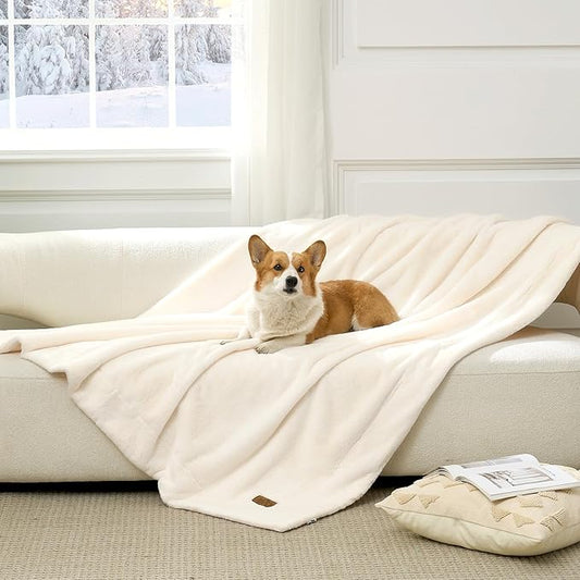 Cozy Bliss Leakproof Faux Fur Pet Blanket in Cream White front view with a dog sitting on it. #color_Cream White