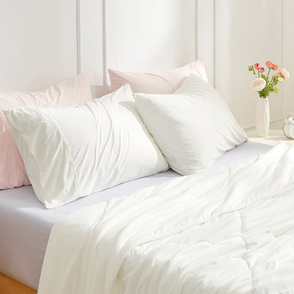 Cooling Pillowcases on bed with cozy comforter, white and pink bedding #color_Off White