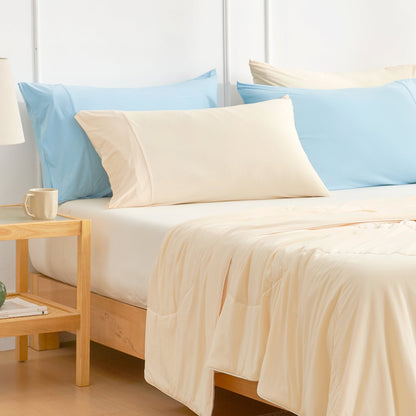 Cream Cooling Pillowcases on a bed with a matching comforter. Cozy bedding for better sleep. #color_Yellow