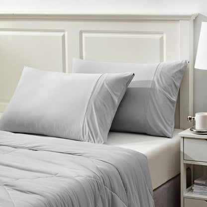 Gray cooling pillowcases on bed, breathable Arc-Chill fabric, soft cozy bedding set for cool sleep #color_Light Grey