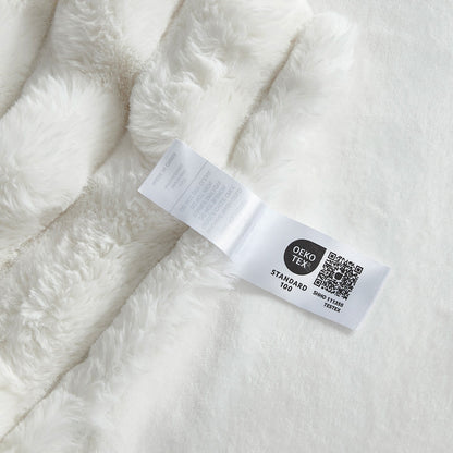 Close-up of OEKO-TEX certified label of  Cozy Bliss faux fur blanket  #color_Cream White