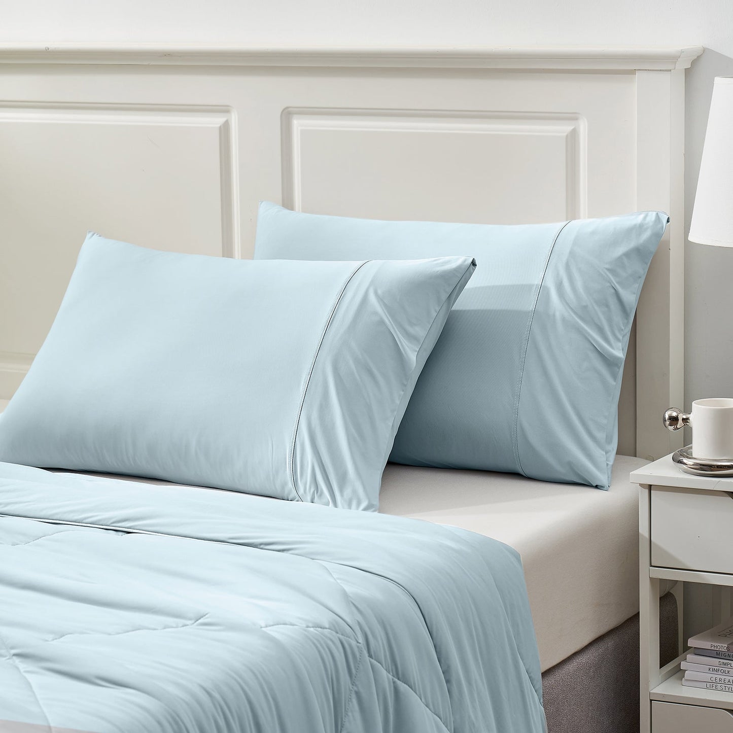 Light blue cooling pillowcases and comforter set on bed, ideal for cool and comfortable sleep; breathable fabric #color_Cool Blue