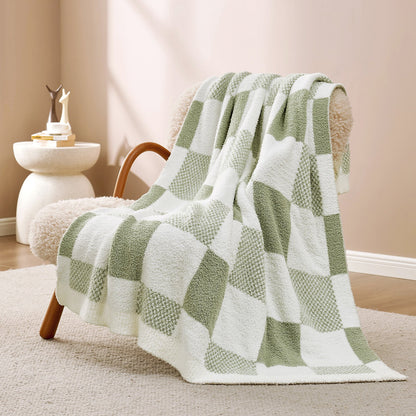 Checkered Feather Yarn Throw Blanket in Sage Green & White front view draped over an armchair, showcasing soft feather yarn texture and checkered pattern design. #color_Sage Green & White