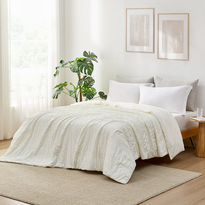 White Seersucker Cooling Comforter on a bed, cozy bedding for a good night's sleep #color_Cream White