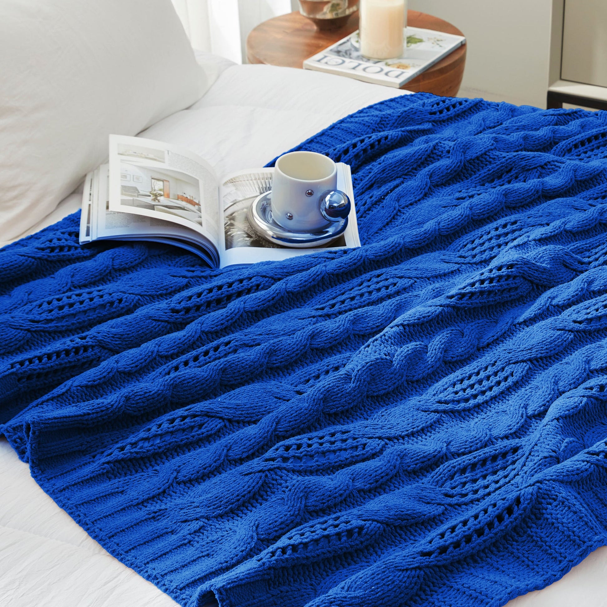 Chenille Cable Knit Throw Blanket in Blue styled on a bed in a cozy bedroom, adding a calm and stylish look. #color_Blue