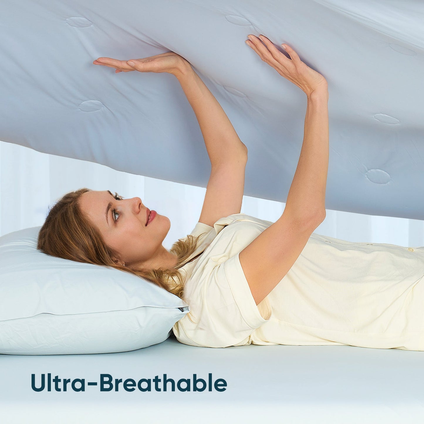 Women touching breathable cooling comforter.#color_Cool Blue