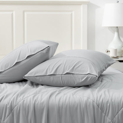 Gray Cooling Pillowcases set on a bed, breathable and comfortable bedding for hot sleepers. #color_Light Grey
