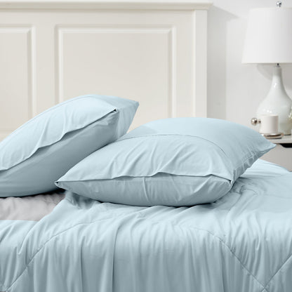 Light blue cooling pillowcases on bed; breathable, soft material for comfortable sleep. #color_Cool Blue