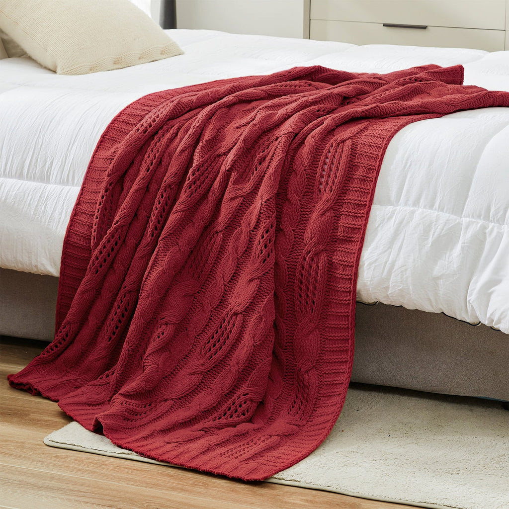 Chenille Cable Knit Throw Blanket in Red styled on a bed in a modern bedroom, adding warmth and a bold cozy look. #color_Red