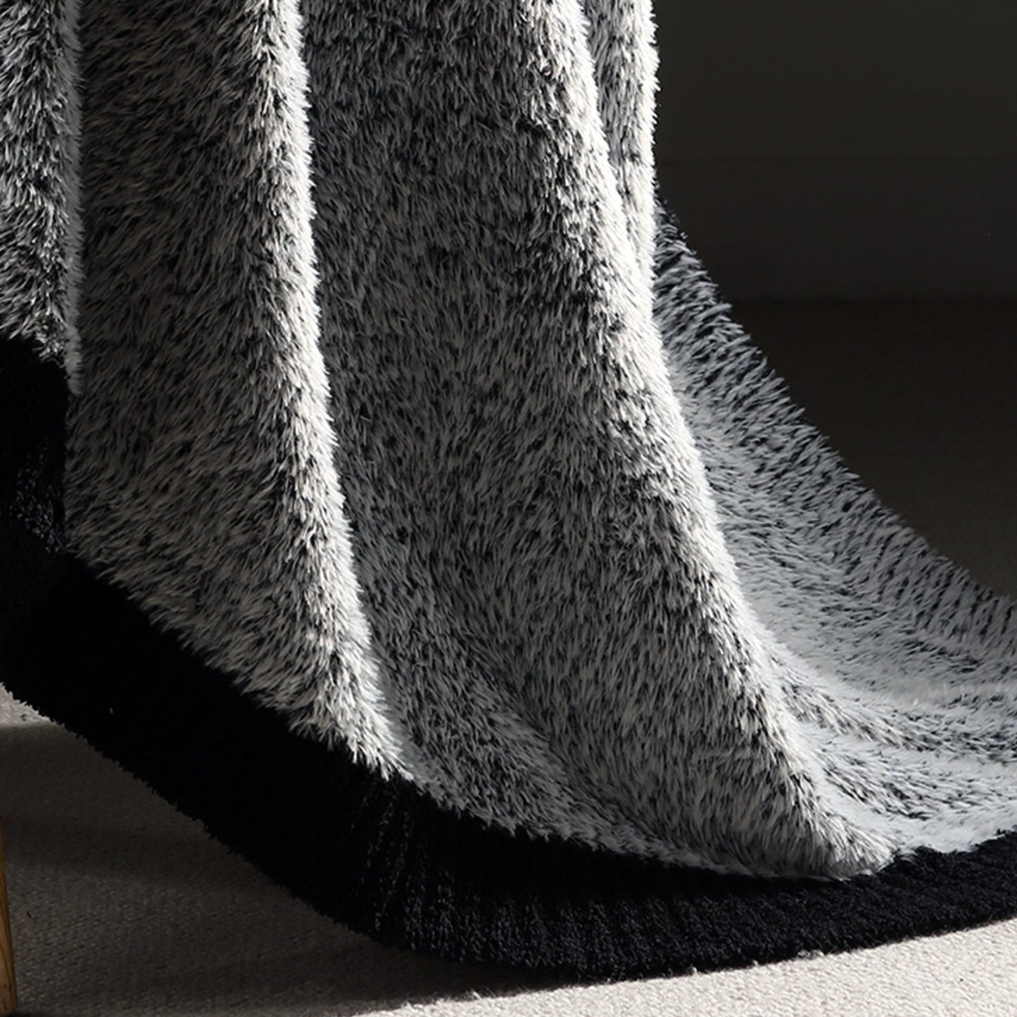 Close-up of plush feather yarn on Faux Mink Feather Knit Throw Blanket in Black highlighting dense and soft fabric texture. #color_Black