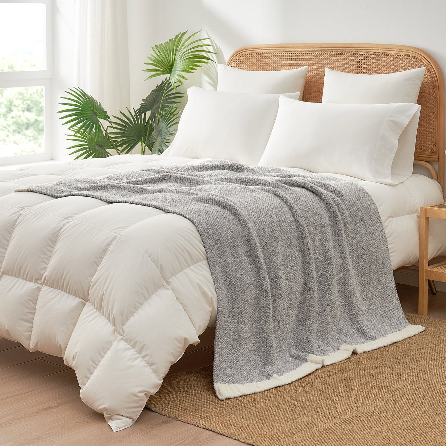 Heather Feather Yarn Throw Blanket in grey styled on a bed, enhancing bedroom decor with a soft, elegant and cozy layered look. #Color_Grey