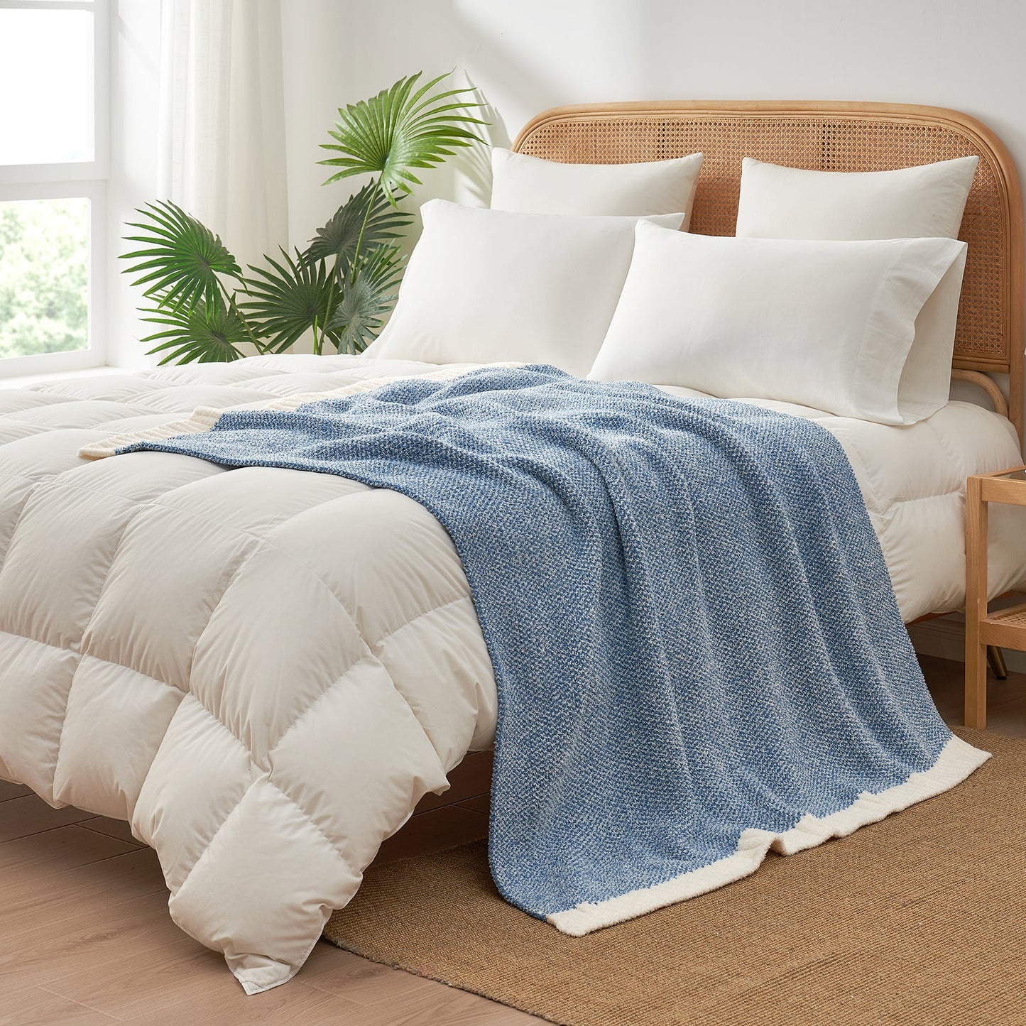 Heather Feather Yarn Throw Blanket in pale blue styled on a bed, enhancing bedroom decor with a soft, elegant and cozy layered look.  #Color_Pale Blue